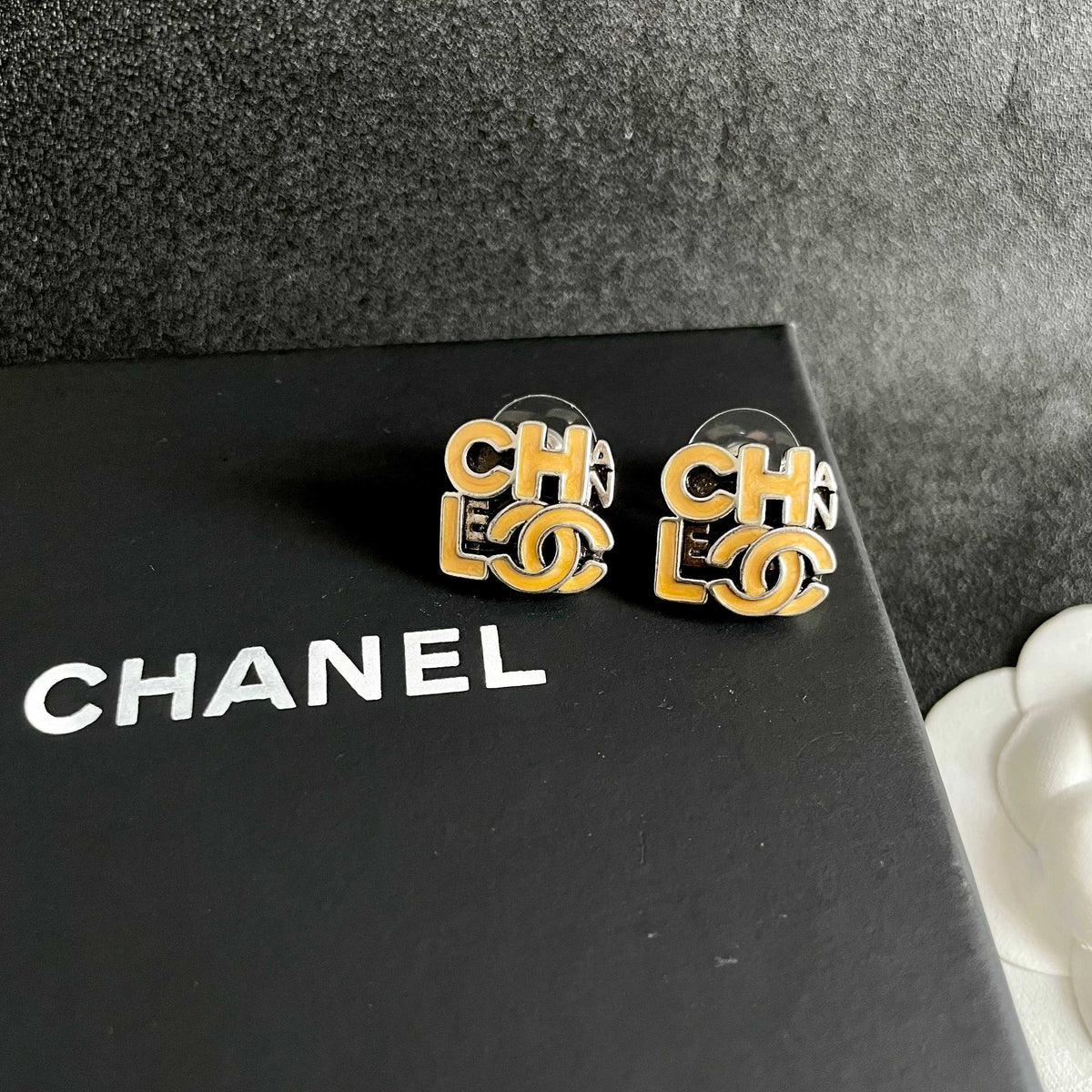 Double-C Emblem Stud Earrings in Polished Metal-Tone – Design 212 detail view