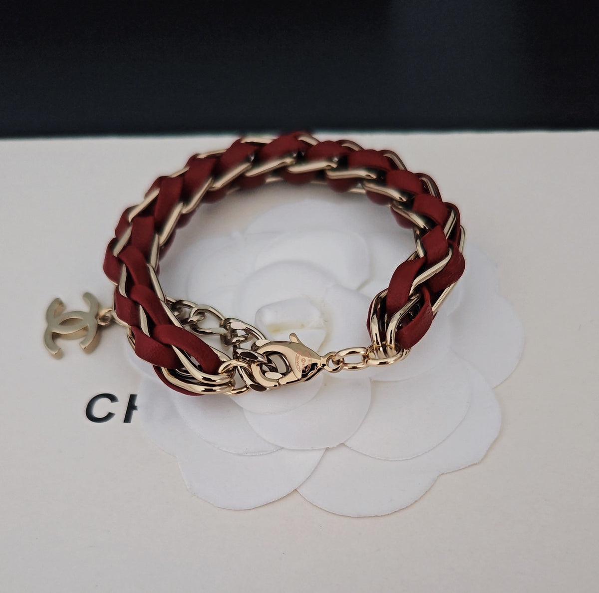 Signature Emblem Bracelet in Gold-Tone – Red Detail close-up detail
