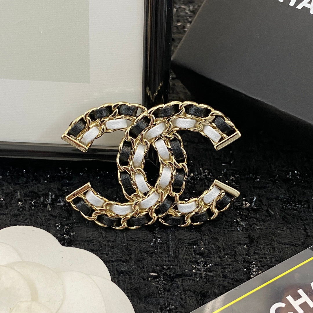 Signature Emblem Brooch in Polished Metal-Tone – Black Detail detail view