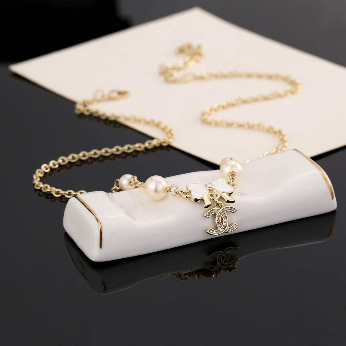 Bow Pendant Necklace in Polished Metal-Tone front product view