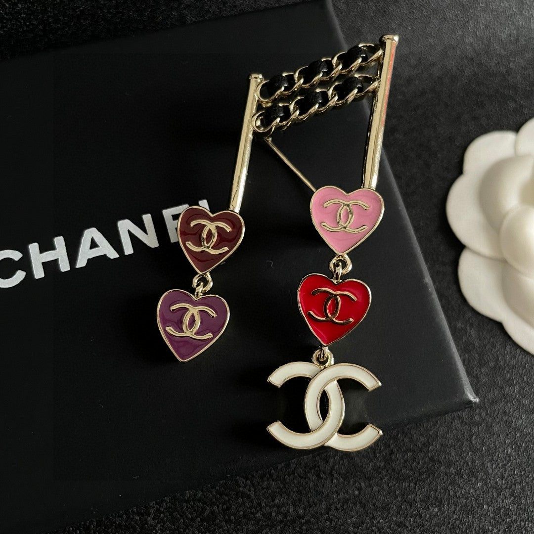 Double-C Emblem Brooch in Polished Metal-Tone – Heart Detail detail view