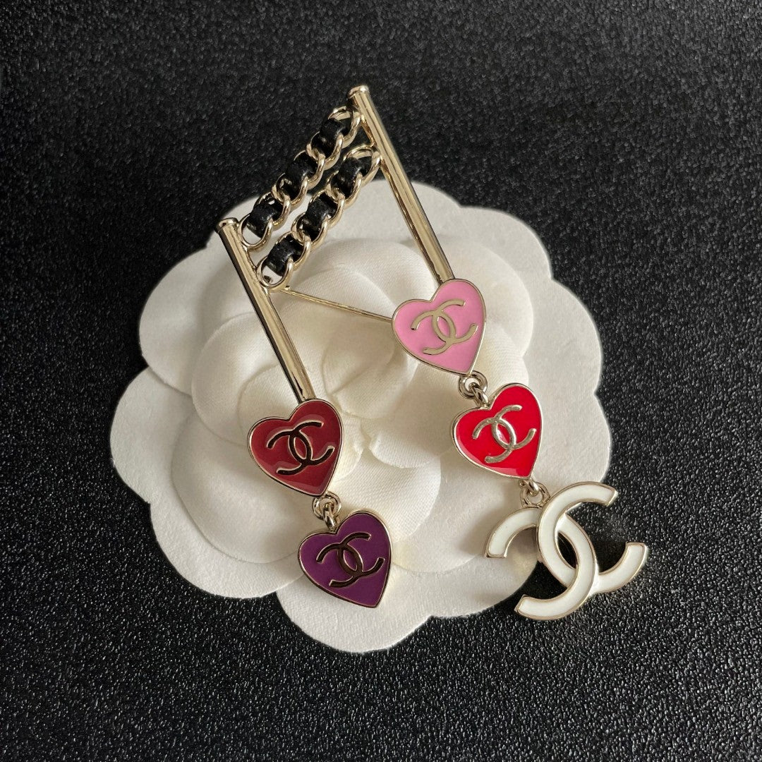 Double-C Emblem Brooch in Polished Metal-Tone – Heart Detail front product view