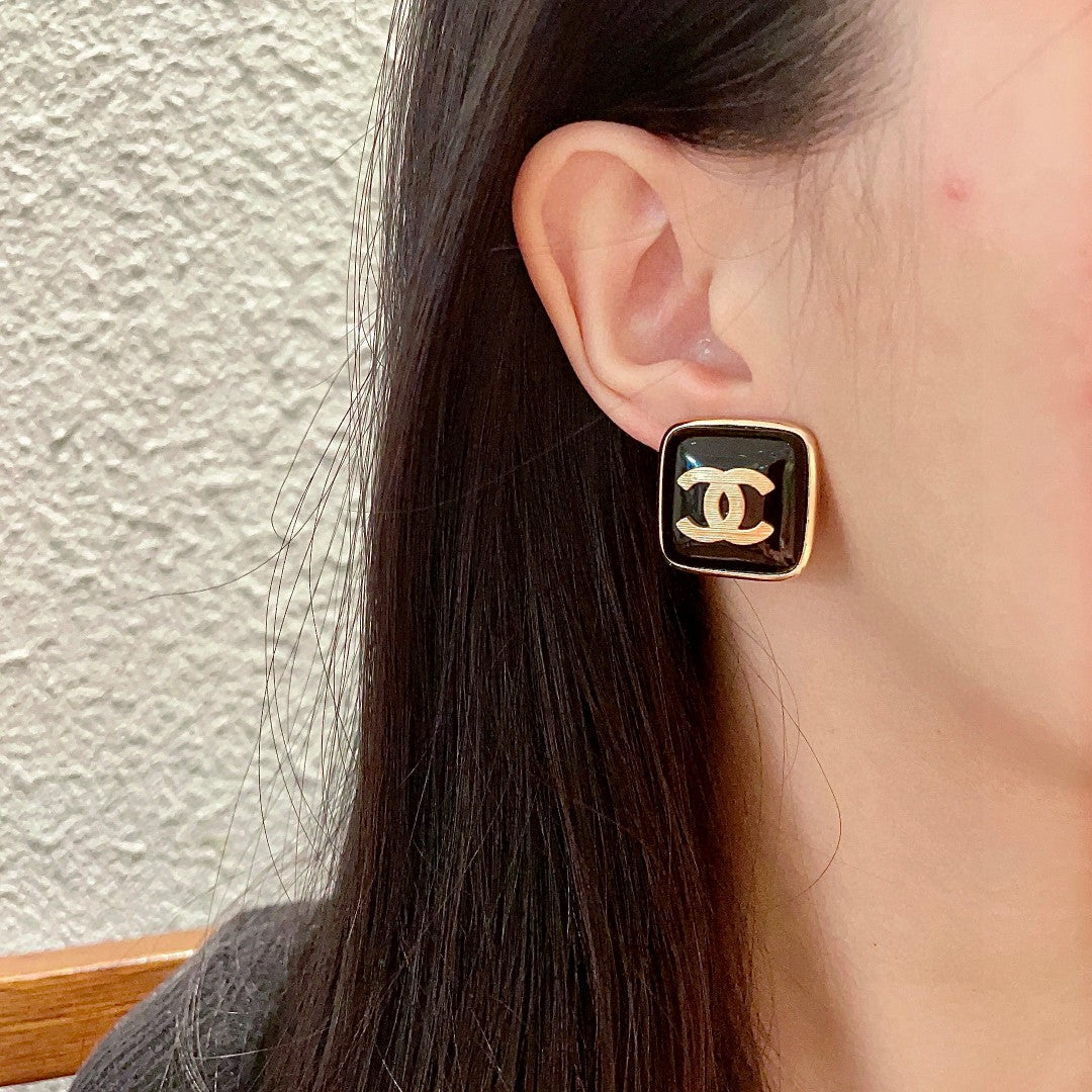 Double-C Emblem Stud Earrings in Polished Metal-Tone – Design 295 detail view