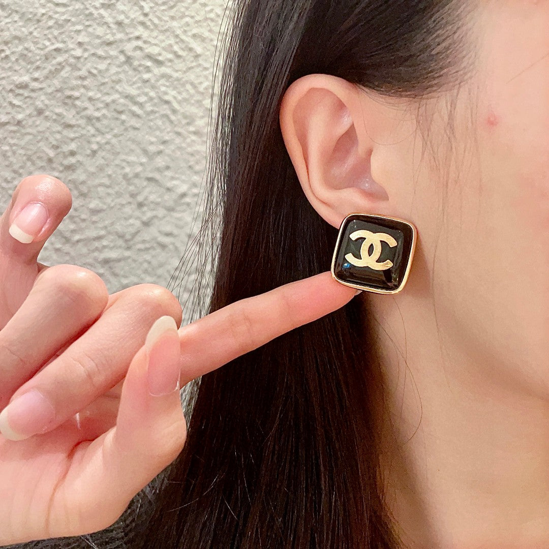 Double-C Emblem Stud Earrings in Polished Metal-Tone – Design 295 front product view