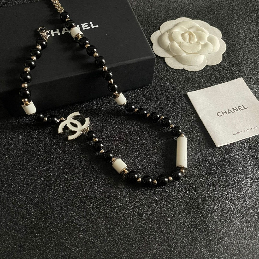 Double-C Emblem Pendant Necklace in Polished Metal-Tone – Black Detail styled product view