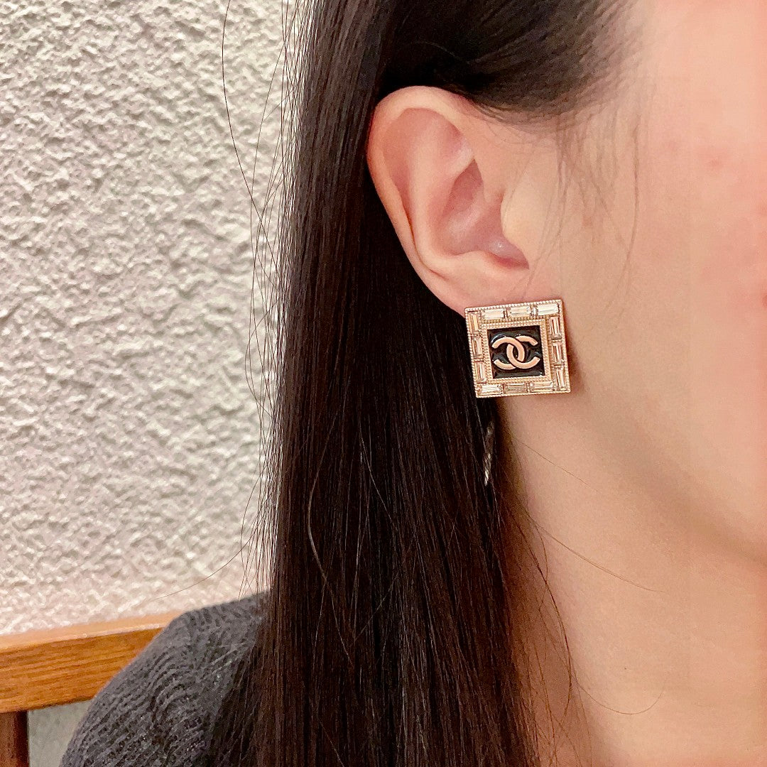 Double-C Emblem Stud Earrings in Polished Metal-Tone – Design 148 detail view