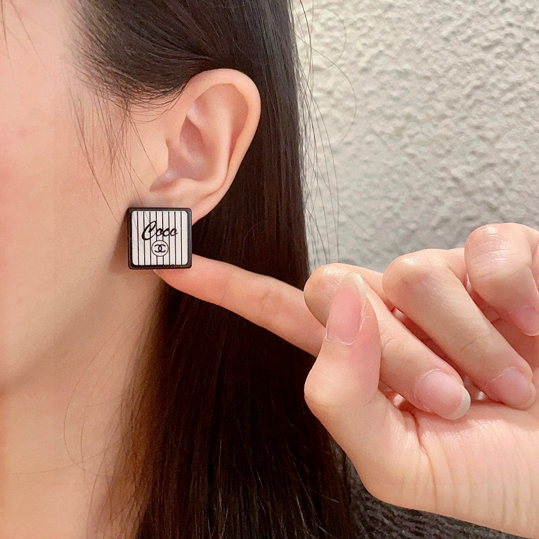 Double-C Emblem Stud Earrings in Polished Metal-Tone – Design 232 front product view