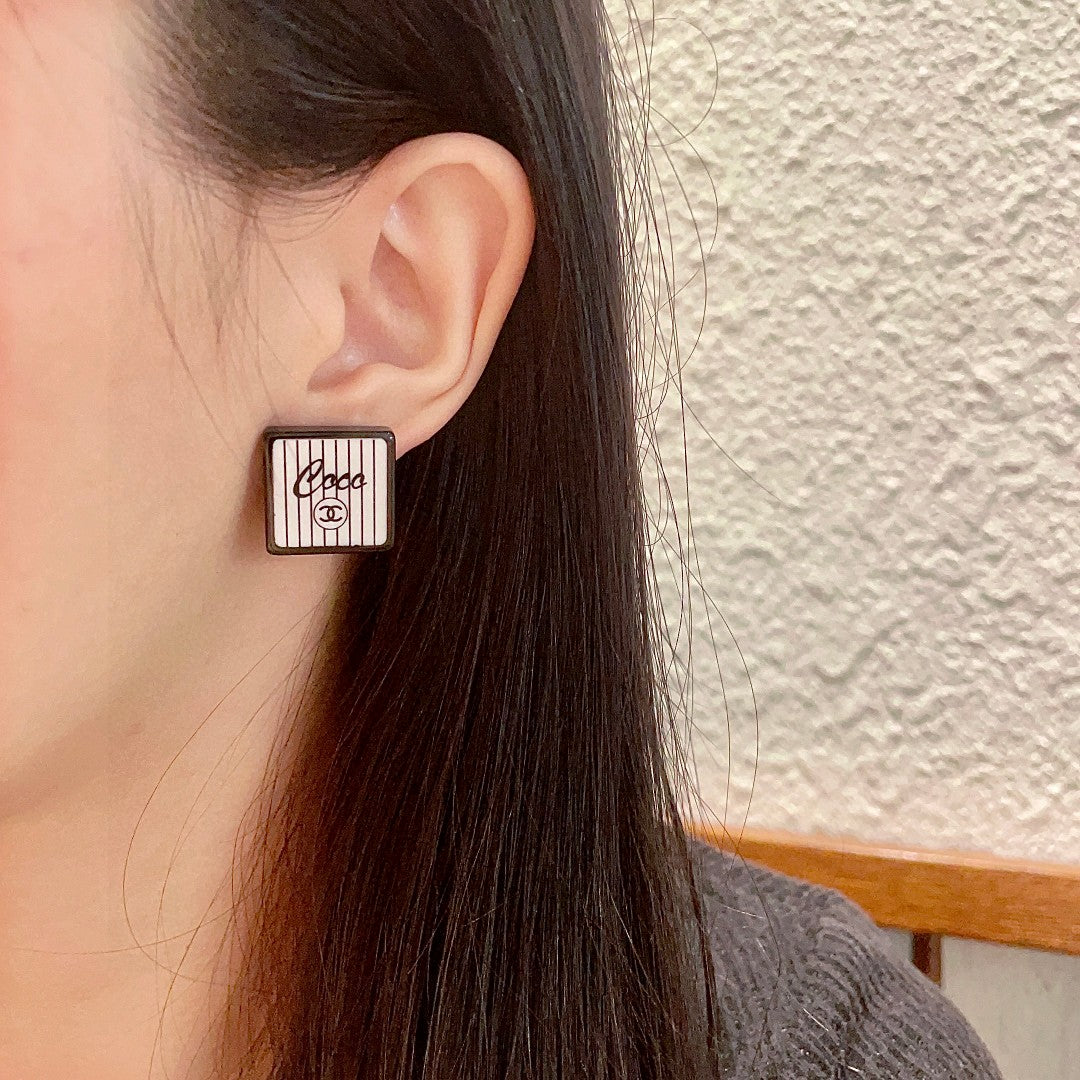 Double-C Emblem Stud Earrings in Polished Metal-Tone – Design 232 detail view