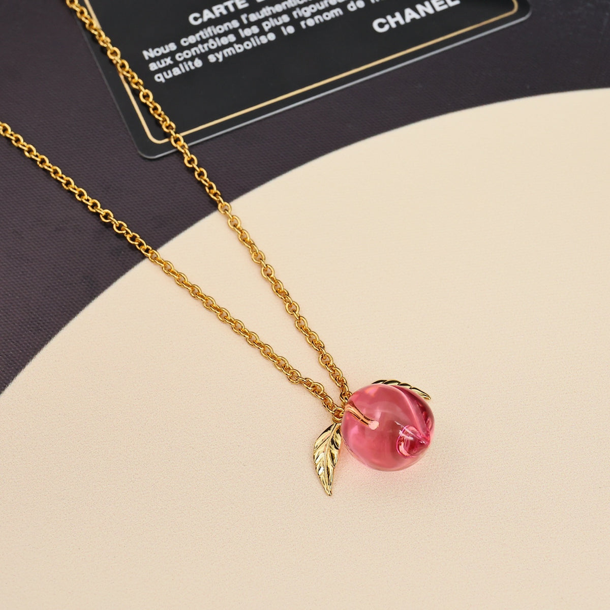 Signature Emblem Pendant Necklace in Polished Metal-Tone – Pink Detail detail view