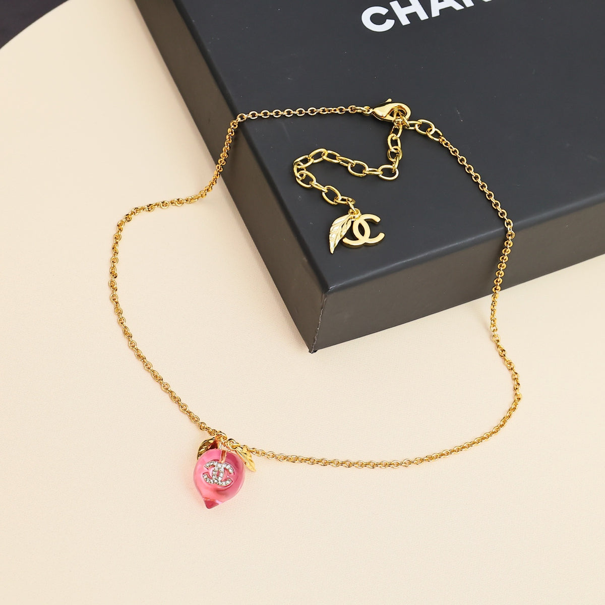 Signature Emblem Pendant Necklace in Polished Metal-Tone – Pink Detail front product view