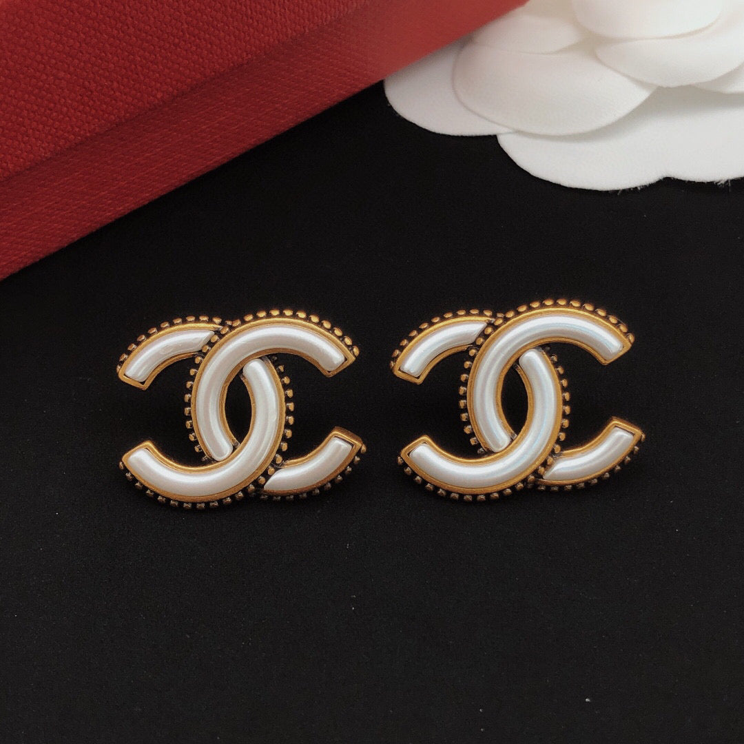Double-C Emblem Stud Earrings in Gold-Tone – White Detail close-up detail