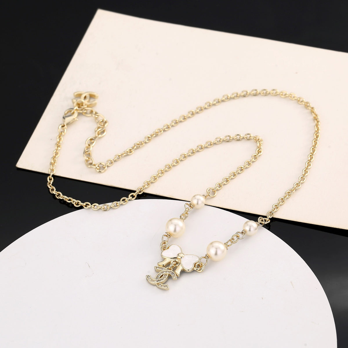 Bow Pendant Necklace in Polished Metal-Tone front product view