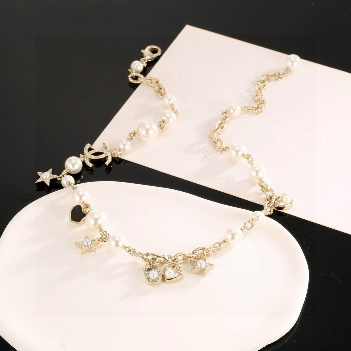 Double-C Emblem Pendant Necklace in Polished Metal-Tone – Star Detail styled product view