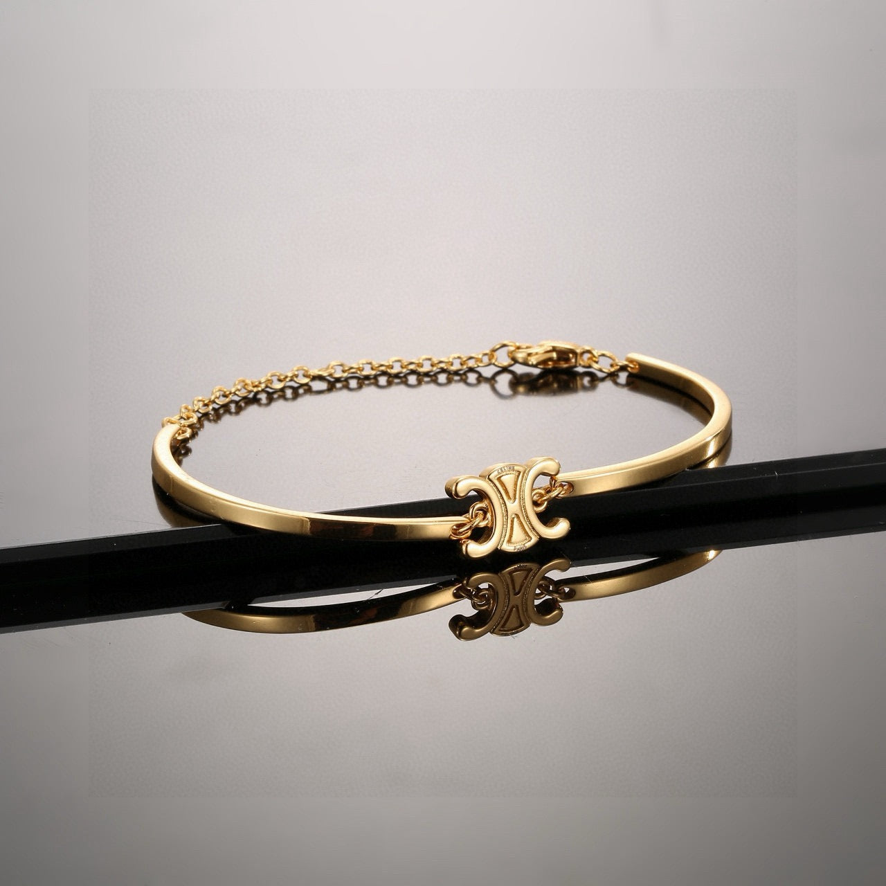 Triomphe-Inspired Emblem Cuff Bracelet in Gold-Tone front view